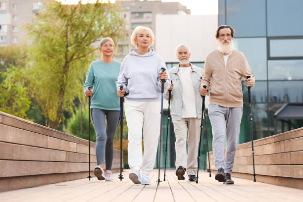 istock Group of senior people performing Nordic walking outdoors. Low angle view 1946087927