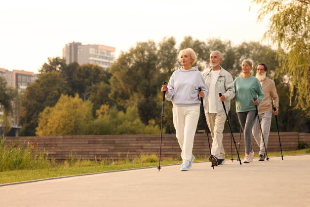 istock Group of senior people performing Nordic walking outdoors, space for text. Low angle view 1946089505