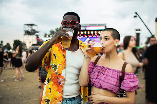 Happy young couple is enjoying at a music festival