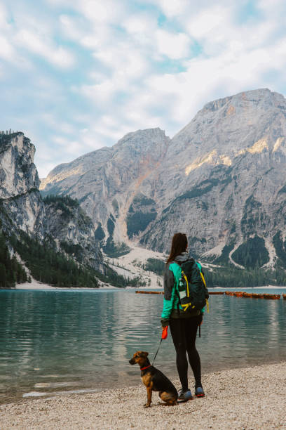 istock female hiker enjoys the outdoors in Dolomites with her dog 1946120310