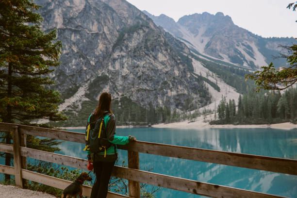 istock female hiker enjoys the outdoors in Dolomites with her dog 1946134162