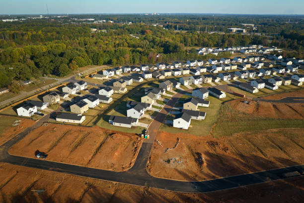 Ground prepared for building of new residential houses in South Carolina suburban development area. Concept of growing american suburbs Ground prepared for building of new residential houses in South Carolina suburban development area. Concept of growing american suburbs. basement construction site construction blueprint stock pictures, royalty-free photos & images