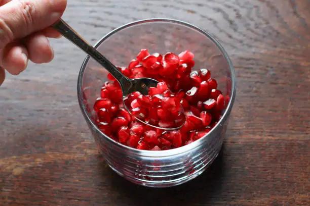 Pomegranate seeds in a glass bowl