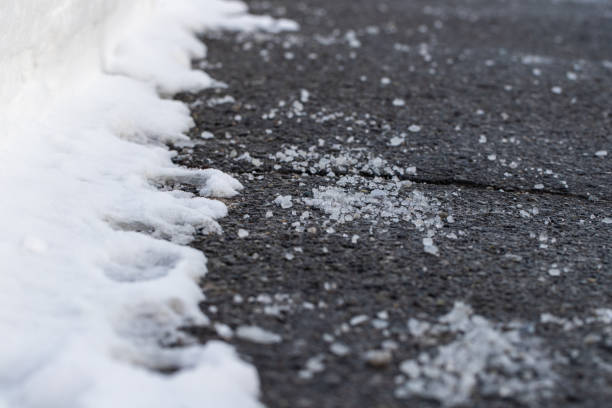 istock Road with salt for melting snow in winter. 1946272008