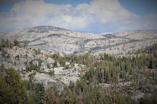 This is the view from Tioga Pass in California. Tioga Pass is a mountain pass in the Sierra Nevada mountain range. State Route 120 runs through it. The pass is located at approximately 10000 feet elevation. The pass is open during summer and generally closed during winter due to snow accumulation.