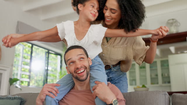 Happy, family sofa and piggyback play of a mother, dad and child together in a home with a smile. Bonding, fun and flying game with mom, father and young girl with parent love and care in a house