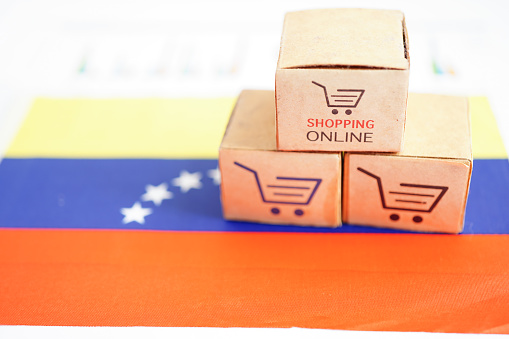Online shopping, Shopping cart box on Venezuela flag, import export, finance commerce.