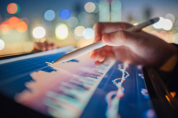 istock Professional trader economists looking at stock charts on trading platform drawing chart 1946361644