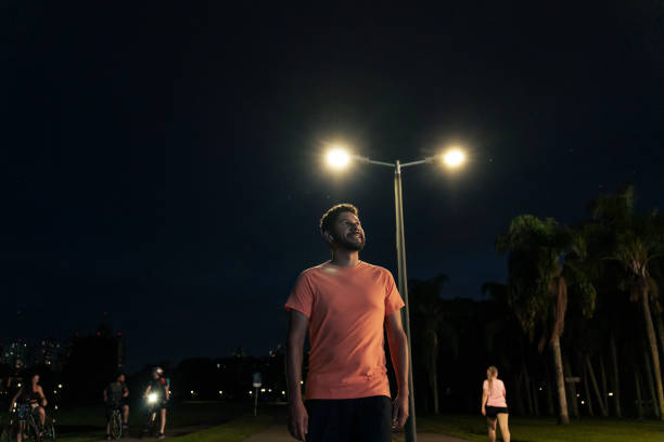 Latino man running at night in the park. City of Curitiba, Paraná, Brazil.