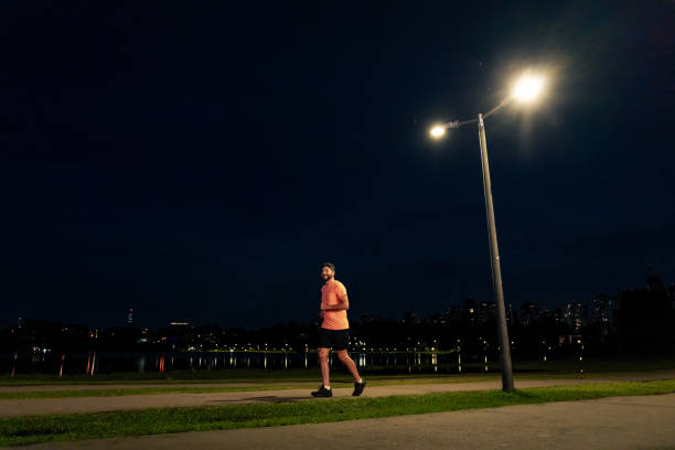 istock Latino man running at night in the park 1946382926
