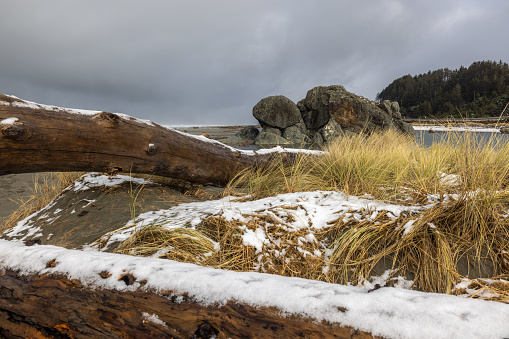 Turtle rock beach covered in snow after a rare winter storm brought snow to the Southern Oregon coast late February 2023