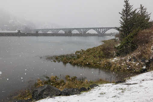 Isaac Lee Paterson bridge expanding across the Rogue river in extreme and rare winter conditions, Gold Beach, Oregon late February 2023