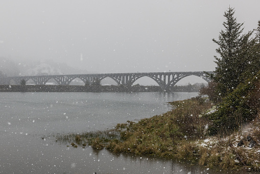 Isaac Lee Paterson bridge expanding across the Rogue river in extreme and rare winter conditions, Gold Beach, Oregon late February 2023