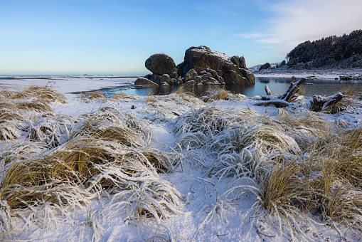 Popular rock feature in Gold Beach Oregon known as turtle rock covered with snow in a rare winter storm in February 2023