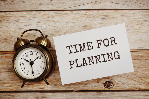 istock Time for planning text message with alarm clock on wooden background 1946388184