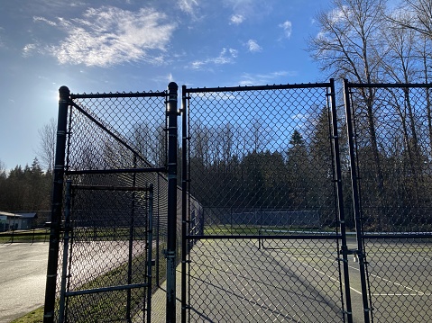 Outdoor tennis court in sunshine.