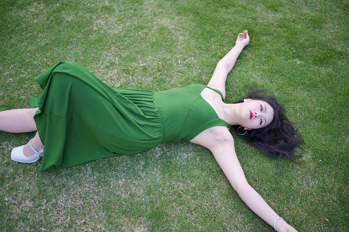 Beautiful woman lying on the grass
