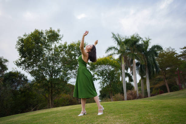 Asian woman dancing outdoors