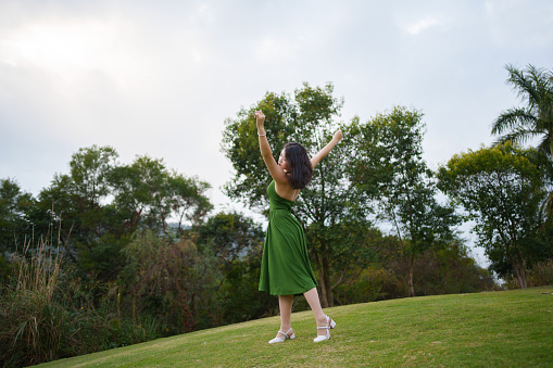 Asian woman dancing outdoors