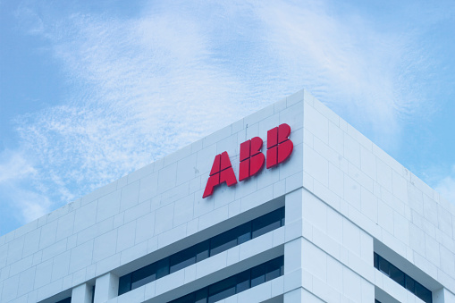 Jakarta, Indonesia - November 24, 2023:  A sign for the Swiss-Swedish industrial automation and power transmission company ABB on an office building, with blue sky in the background.