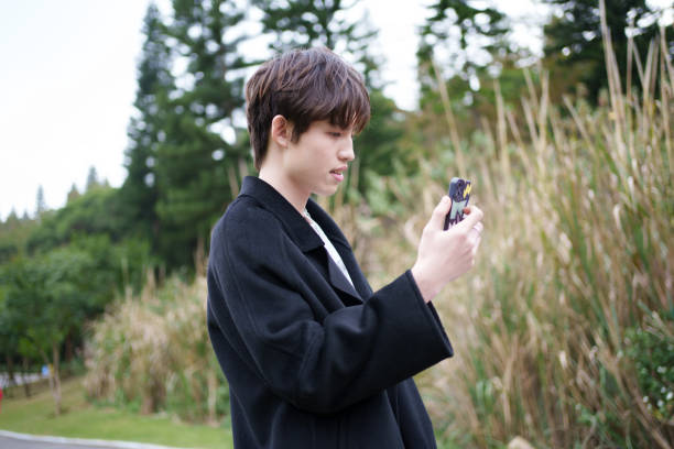 istock Asian man looking at smartphone 1946498941