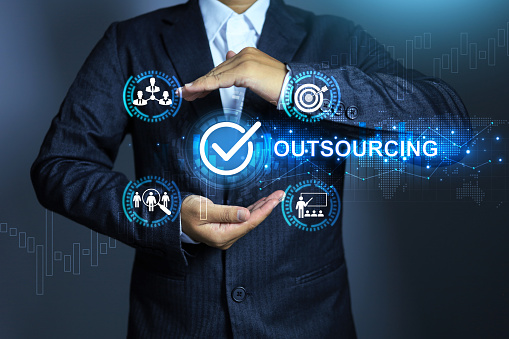 Outsourcing manpower concept with businessman holding checkmark to approved hiring outsource employee or partnership worker to be a staff in company with contract periods