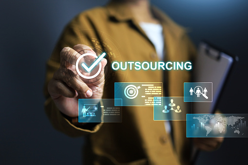 Outsourcing manpower concept with businessman tick on checkmark to approved hiring outsource employee or partnership worker to be a staff in company with contract periods