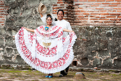 Woman wearing a pollera Panama's national costume, and man wearing a traditional tunic mole at Panama la Vieja ruins,  Panama City, Panama, Central America