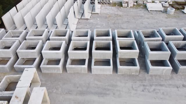 Aerial view of concrete pipes stacked in a storage yard for industrial construction.