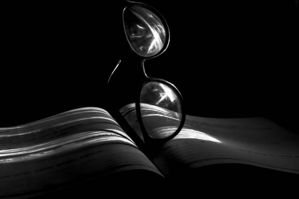 istock glasses resting on a book in the dim light 1946890987