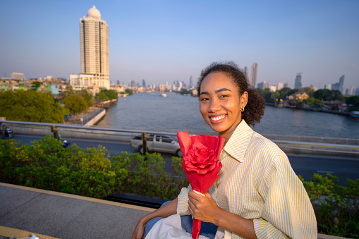 Young woman get a rose for valentine 's day. Love and travel.