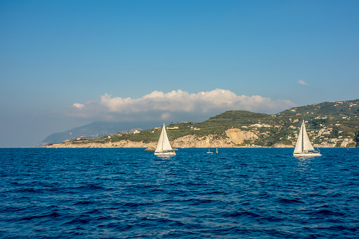 Sailboats on the Mediterranean Sea between the Isle of Capri and Sorrento, Italy.