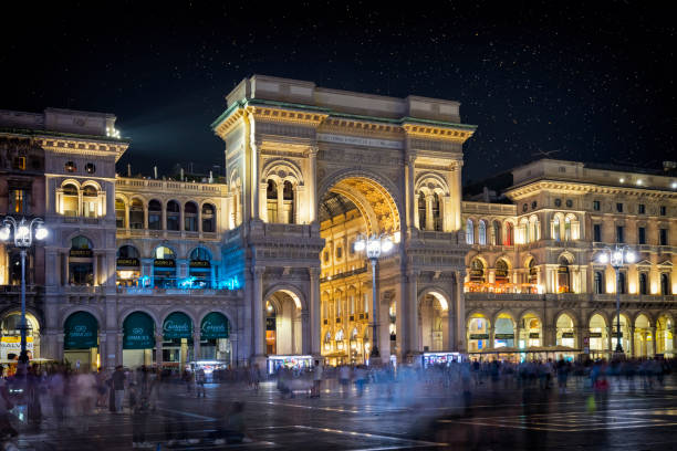 holidays in italy - piazza duomo with the galleria vittorio emanuele ii in milan by night - shopping milan italy retail shopping mall stock-fotos und bilder