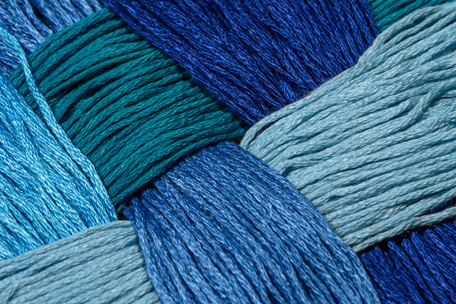A background of interwoven blue strings in various shades of blue isolated