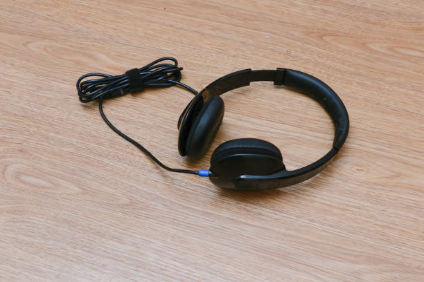 istock headphones on wooden background 1947002699