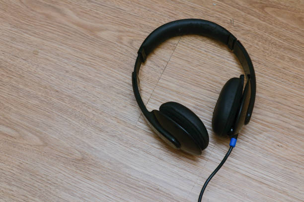 istock headphones on wooden background 1947003724