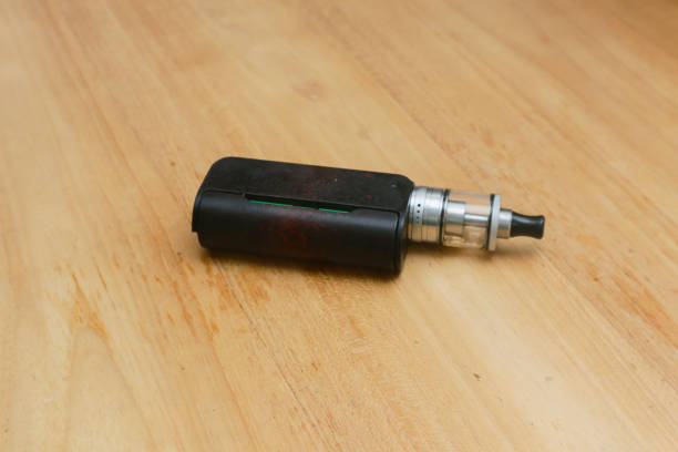 istock vape or e cigarette over wooden background 1947004241