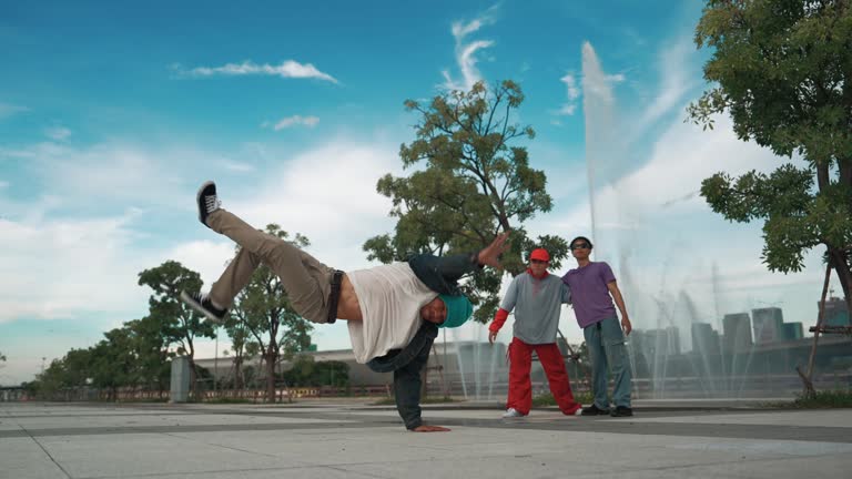 Professional attractive hipster perform street dance with fountain. Sprightly.