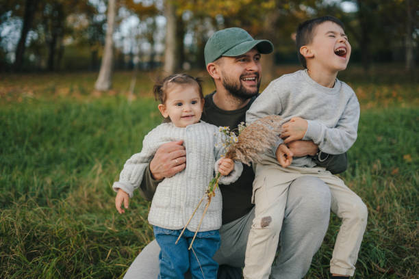 Happy father with daughter spending quality time together outdoors. People concept.
