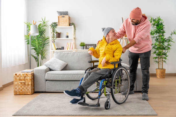 istock Happy disabled man with a and friend at home 1947159927