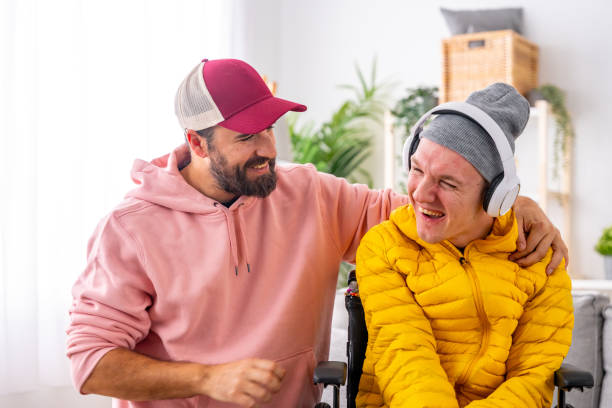 istock Disabled man and caregiver during art therapy session with music 1947165130
