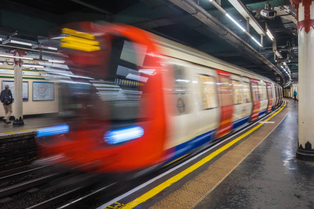 London Underground subway train zooming through Temple station.