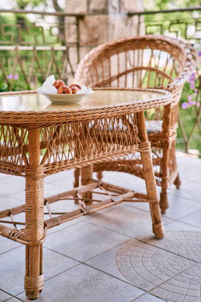 istock Plate with peaches stands on a wicker rattan table on the terrace 1947170799