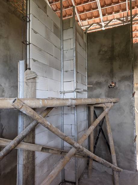istock Unfinished construction and bamboo stilt 1947204479