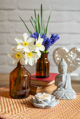 Grape Hyacinth bouquet with spring flowers, book and candle