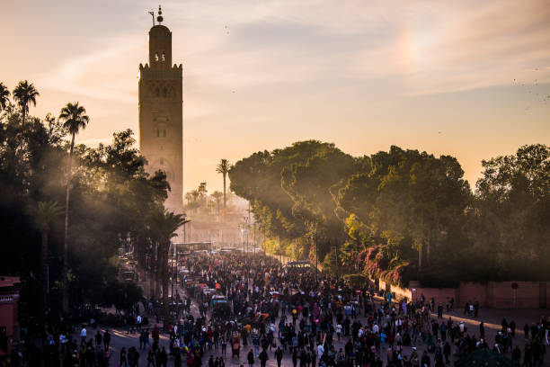 Marrakech, Morocco-February 28,2023: A typical street in the ancient Medina district of Marrakech. Photo contains local people doing various activities.