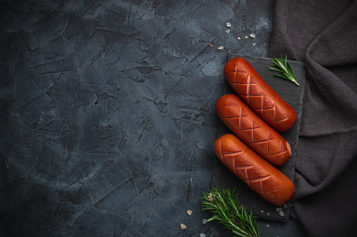 Grilled barbecue sausages with rosemary and spices. Free space for your text.