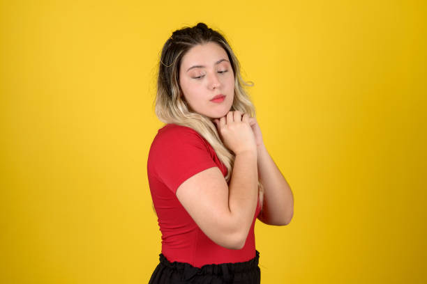 istock Beautiful young woman looking down during photo session in studio 1947296373