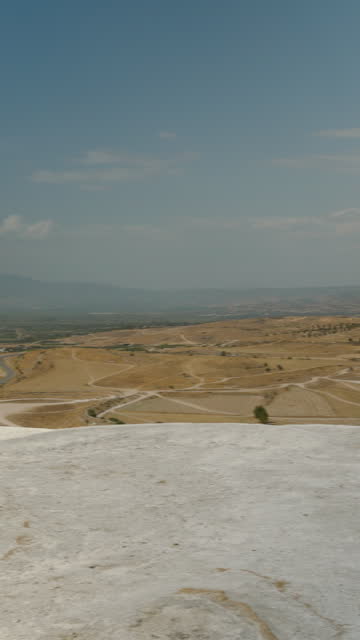 Vertical video. White mountains, travertines in Pamukkale, panoramic view from the observation deck.