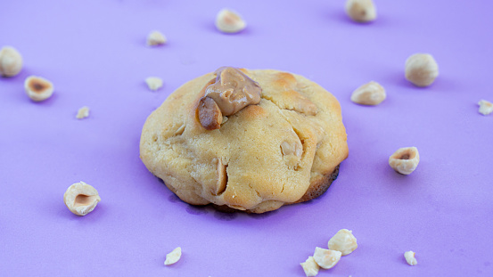 Table of homemade hazelnut chip cookies Stock Image on purple background